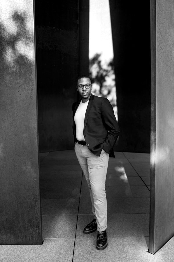 Black and white portrait of Gabriel Walker against a dark ground.