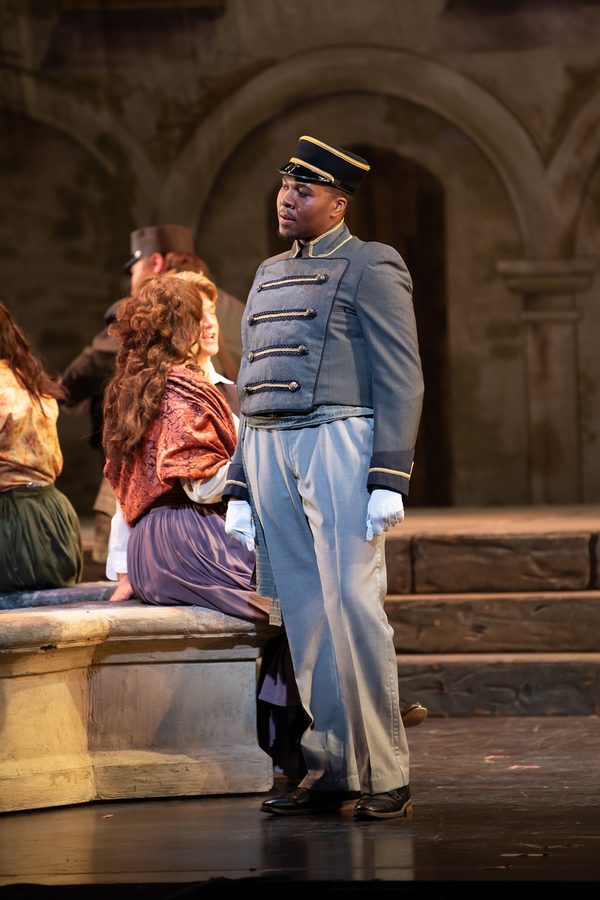 Gabriel Walker as Moralès in Carmen, in military uniform beside the chorus.